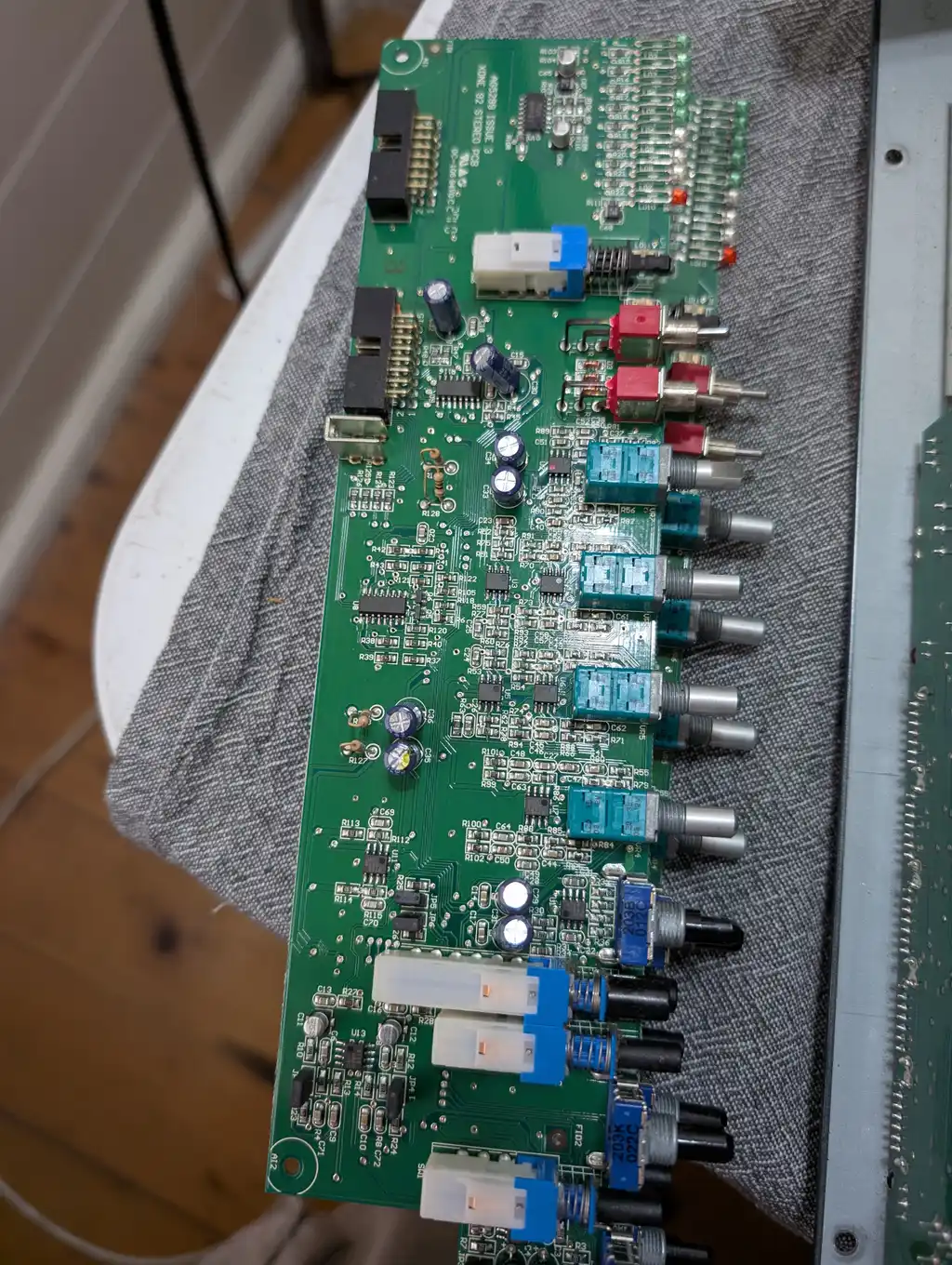 The Allen & Heath Xone:92 mixer's channel board lifted clear of the chassis during the clean, showing the RCA input jacks along its edge and the row of gain and EQ potentiometers.