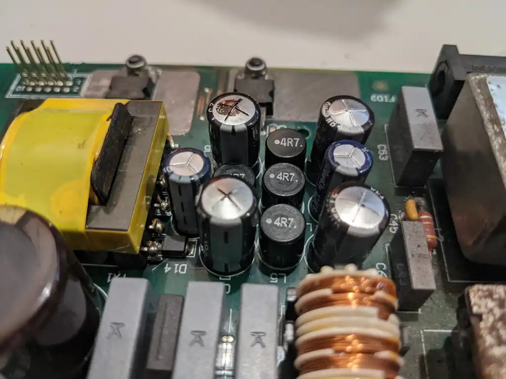 Close-up of the Allen & Heath Xone:92 mixer supply's secondary side, showing the electrolytic capacitors, 4R7 inductors and common-mode choke around the switch-mode transformer.
