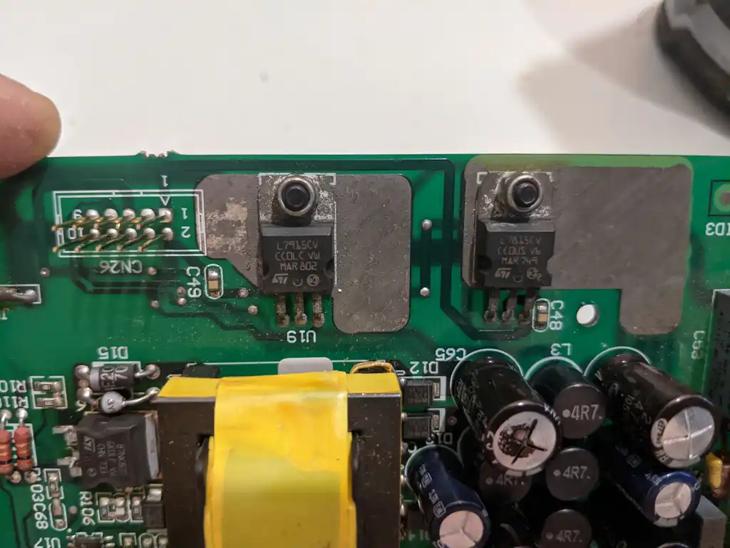 Close-up of the two TO-220 linear voltage regulators on their thermal pads at board positions U18 and U19 of the Allen & Heath Xone:92 mixer's power supply.