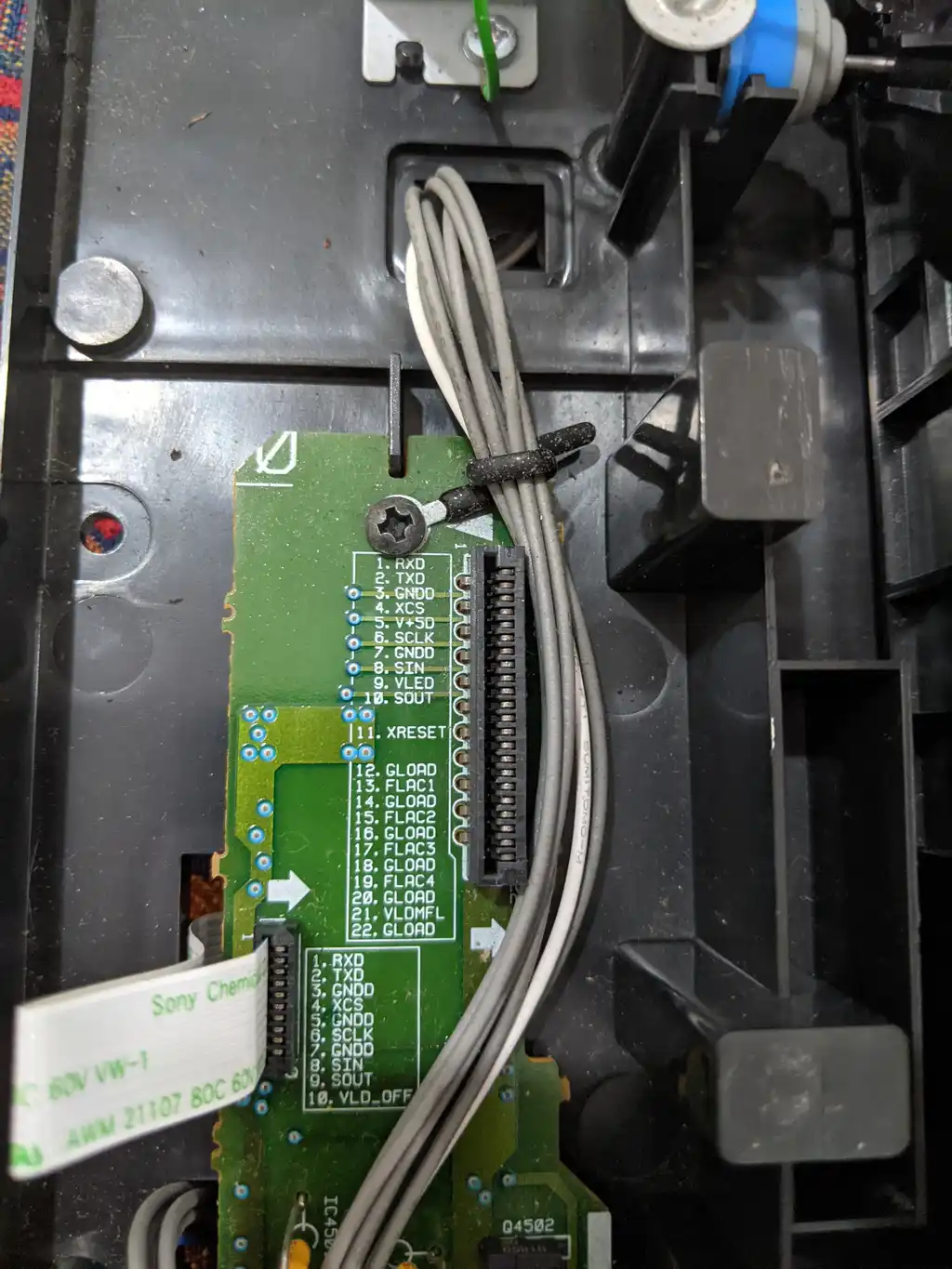 Inside the Pioneer DVJ-1000, the board carrying the 22-pin connector for the control loom, with its flat-flex cable routed alongside.
