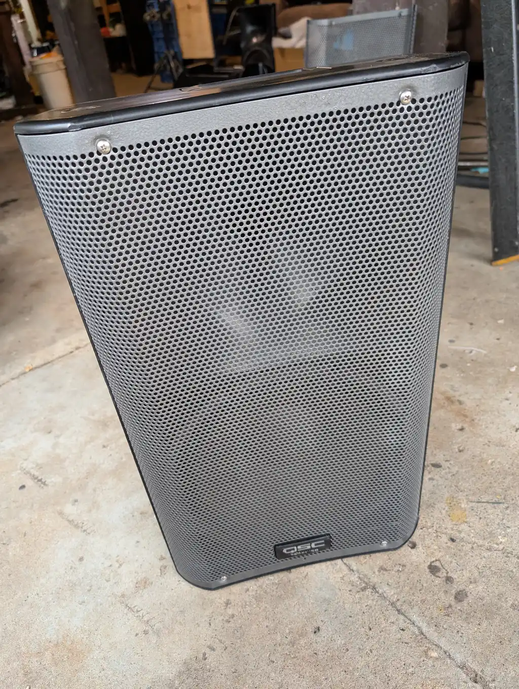 The finished QSC speaker standing on its own, its stripped-and-repainted grilles and handles fitted back onto the cabinet.